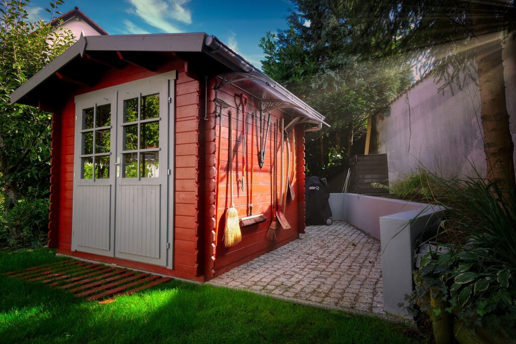 Kleine Gartenhütte aus Holz Gerätehaus Metall oder Holz – Was passt besser in den Garten